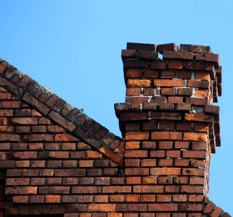 Damaged chimney on an Dearborn home showing cracks and missing mortar
